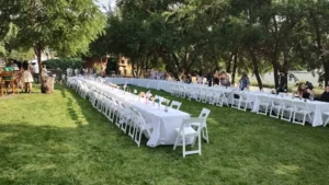 White chairs and tables setup for a wedding dinner